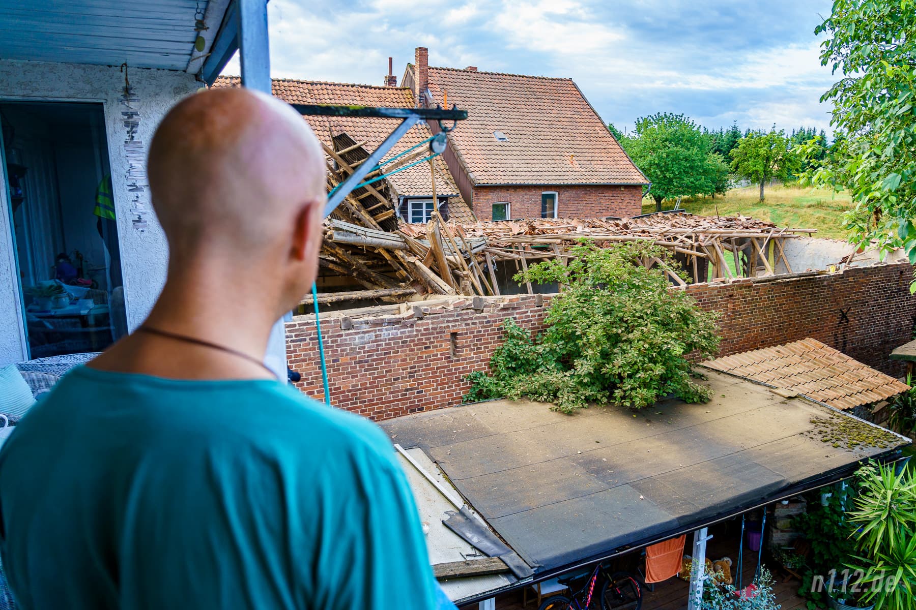 Ein Anwohner blickt auf das eingestürzte Dach, das schon zwei Tage lang ungewöhnliche Geräusche von sich gegeben haben soll (Foto: n112.de/Stefan Hillen)